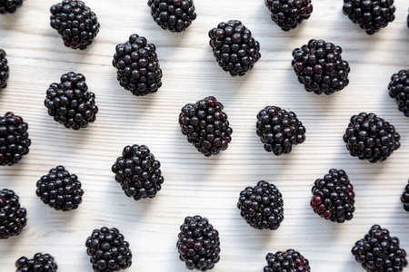 Raw Blackberries on a white wooden background, top view. Flat lay, overhead, from above.の写真素材