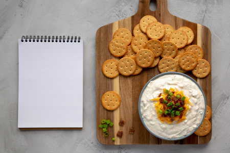 Homemade Crack Dip Appetizer in a Bowl, blank notepad, top view. Flat lay, overhead, from above. copyspace.の写真素材