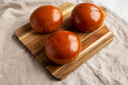 Homemade Brioche Hamburger Buns on a wooden board, side view.の写真素材