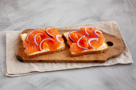 Homemade Smoked Salmon Toast on a rustic wooden board, side view.の写真素材