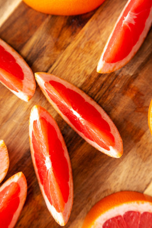Organic Red Ruby Grapefruit on a Wooden Board, top view. Overhead, from above, flat lay. close-up.の写真素材