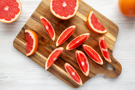 Organic Red Ruby Grapefruit on a Wooden Board, top view. Overhead, from above, flat lay.の写真素材