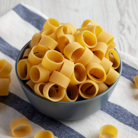 Raw Uncooked Pasta Calamarata in a Bowl, side view.の写真素材