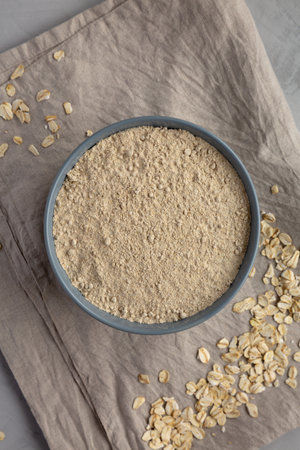 Organic White Oat Flour in a Bowl on a gray background, top view. Flat lay, overhead, from above.の写真素材