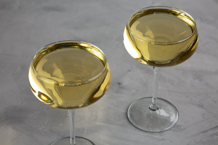 Sparkling Champagne in a Coupe Glass on a gray background, side view.の写真素材