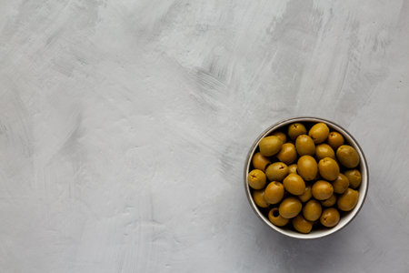 Marinated Green Pitted Olives in a Bowl, top view. Flat lay, overhead, from above. copyspace.の写真素材