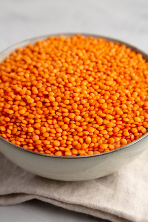 Red Lentils Legume in a Bowl on a gray background, side view. close-up.の写真素材