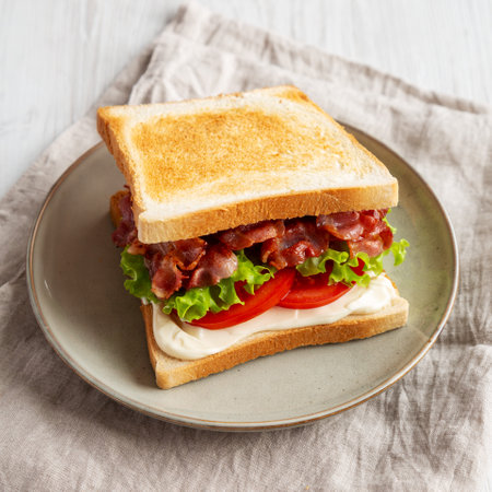Homemade BLT Sandwich (Bacon, Lettuce and Tomato) on a Plate, side view.の写真素材