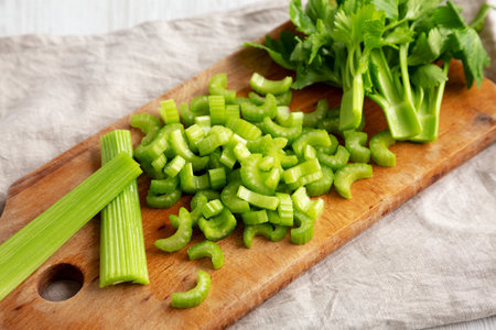 Raw Green Organic Celery on a rustic wooden board, side view.の写真素材