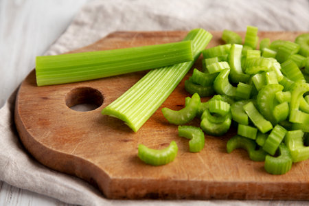 Raw Green Organic Celery on a rustic wooden board, side view. close-up.の写真素材