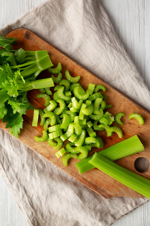 Raw Green Organic Celery on a rustic wooden board, top view. Flat lay, overhead, from above.の写真素材
