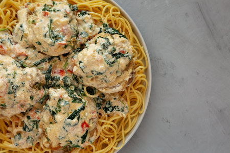 Homemade Creamy Tuscan Chicken with Spinach and Spaghetti Pasta, top view. Flat lay, overhead, from above.の写真素材