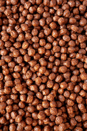 Chocolate Puff Cereal with Milk in a Bowl, top view. From above, overhead, flat lay.