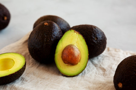 Raw Organic Hass Avocados on a gray background, low angle view.の写真素材