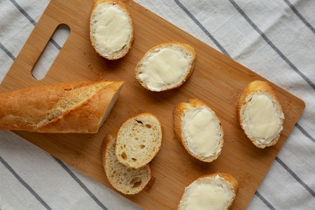 Homemade Bread and Butter on a bamboo board, top view. Flat lay, overhead, from above.