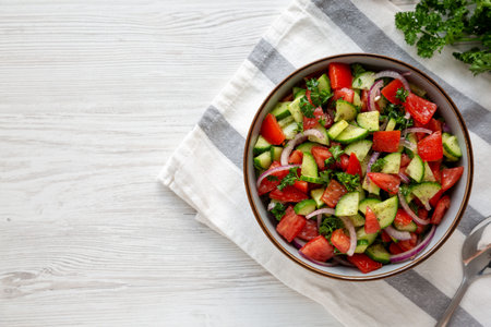Homemade Mediterranean Cucumber Tomato Salad in a Bowl, top view. Flat lay, overhead, from above.の写真素材
