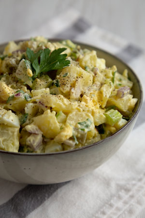 Homemade Potato Egg Salad with Pickles in a Bowl, side view.の写真素材