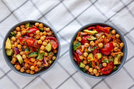 Homemade Avocado Chickpea Salad with Chili Lime Dressing in Bowls, top view.の写真素材