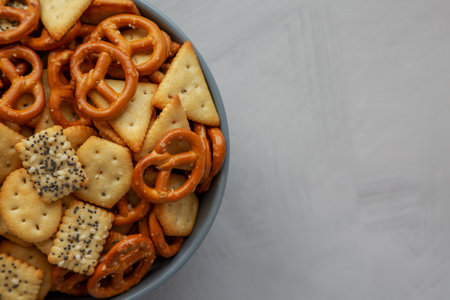 Homemade Party Snack Mix with Crackers and Pretzels in a Bowl, top view. Flat lay, overhead, from above. copyspace.の写真素材