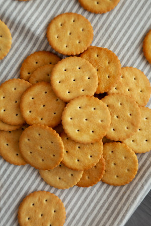 Round Crispy Crackers with Sea Salt on a gray background, top view.の写真素材