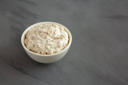 Homemade French Onion Dip in a Bowl on a gray background, side view. Copy space.の写真素材