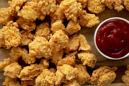 Homemade Crunchy Popcorn Chicken with Ketchup on a Board, top view. Flat lay, overhead, from above.の写真素材