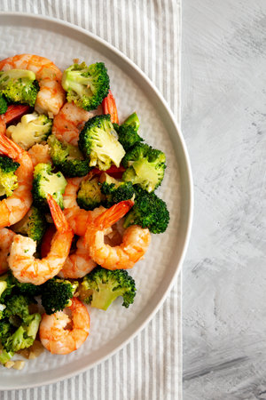 Homemade Garlic Broccoli Shrimp Stir Fry on a Plate, top view. Flat lay, overhead, from above. Copy space.の写真素材
