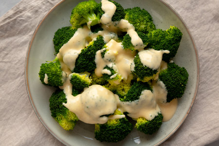 Yummy Cheesy Steamed Broccoli on a Plate, top view. Close-up.の写真素材