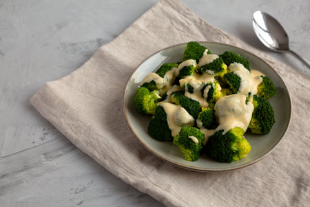 Yummy Cheesy Steamed Broccoli on a Plate, side view. Copy space.の写真素材