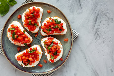Homemade Tomato Ricotta Tartine on a Plate, top view. Flat lay, overhead, from above. Copy space.の写真素材