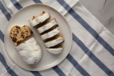 Homemade Christmas Stollen Bread on a Plate, top view. Flat lay, overhead, from above. Copy space.