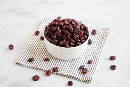 Organic Dried Cranberries in a Bowl, side view.