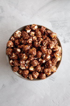 Homemade Chocolate Caramel Popcorn in a Bowl, top view. Flat lay, overhead, from above.