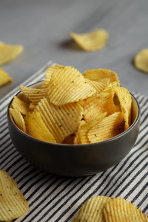 Organic Crinkle Sour Cream and Onion Potato Chips in a Bowl, side view.
