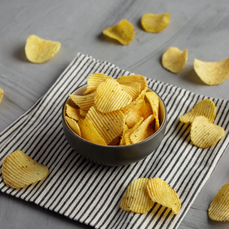 Organic Crinkle Sour Cream and Onion Potato Chips in a Bowl, side view.