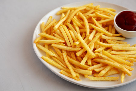 Fried French Fries with Ketchup on a Plate, side view. Copy space.の写真素材