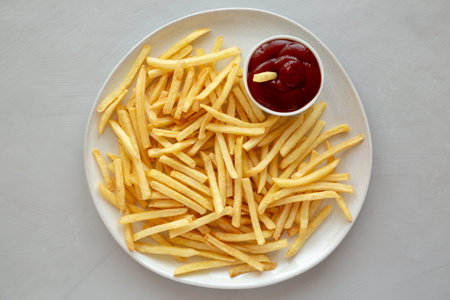 Fried French Fries with Ketchup on a Plate, top view. Flat lay, overhead, from above.の写真素材
