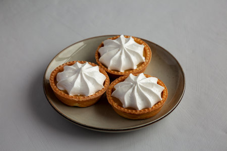 Homemade Lemon Tartlets on a Plate, side view.