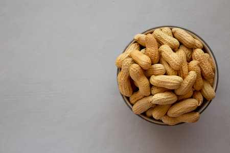 Organic Raw Peanuts in a Bowl, top view. Copy space.