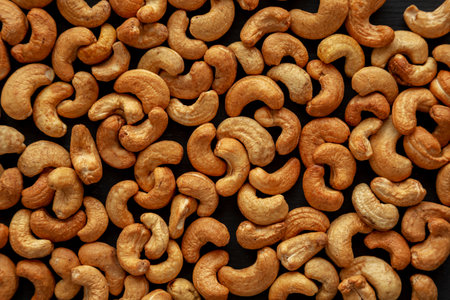 Roasted Organic Cashews on a black background.