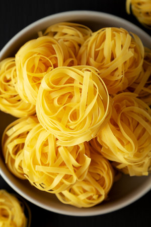 Raw Dry Tagliatelle Pasta in a Bowl, top view.の写真素材