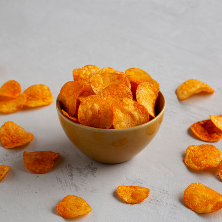 Homemade Flavored Paprika Potato Chips in a Bowl, side view.の写真素材