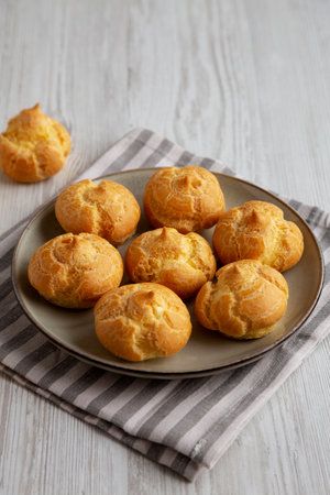 Homemade French Mini Cream Puffs on a Plate, side view.の写真素材