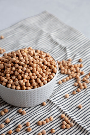 Dry Organic Chickpeas in a Bowl, side view. Copy space.の写真素材