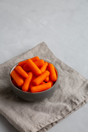 Organic Baby Carrots in a Bowl, side view. Copy space.の写真素材