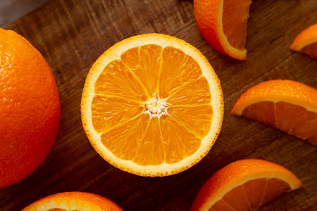 Raw Organic Sweet Oranges on a wooden board, top view. Flat lay, overhead, from above.