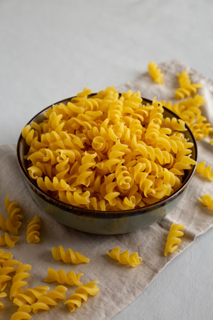 Raw Dry Organic Fusillini Pasta in a Bowl, side view.の写真素材