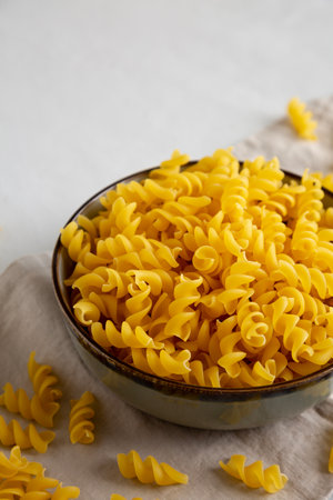 Raw Dry Organic Fusillini Pasta in a Bowl, side view.の写真素材