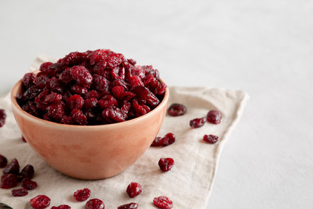 Organic Dried Cranberries in a Bowl, side view. Copy space.の写真素材