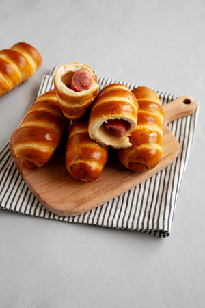 Homemade Beef Sausage in pastry on a wooden board, side view.の写真素材